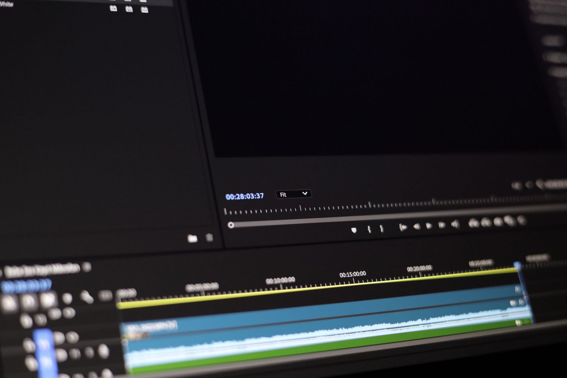 Content creator working on video editing software on a desktop workstation