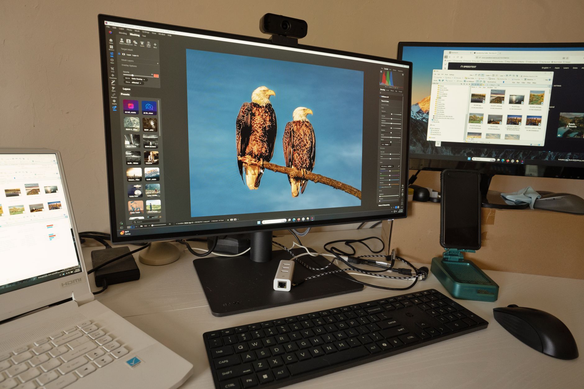 Professional workstation laptop setup with multiple peripherals on a clean desk