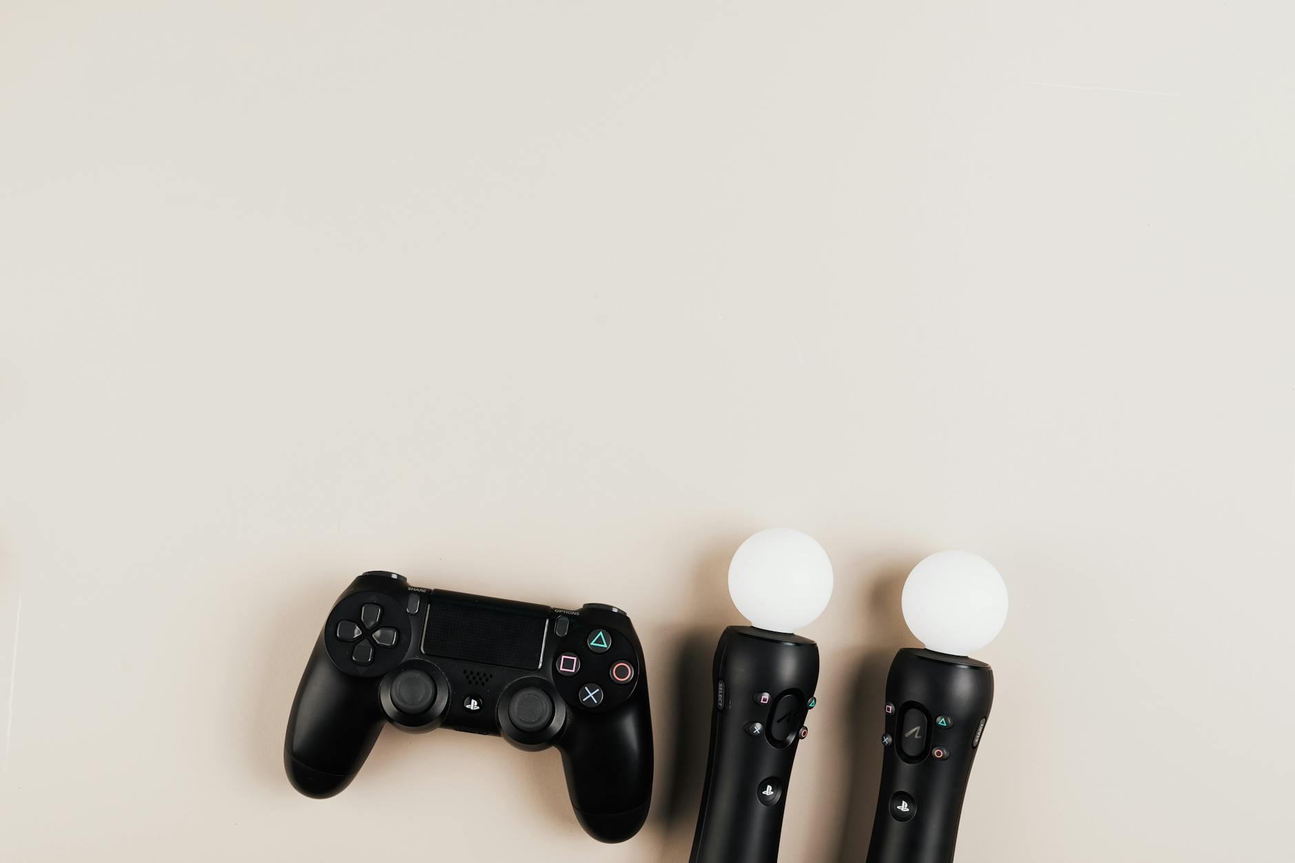 Handheld gaming device resting on desk next to charging cable