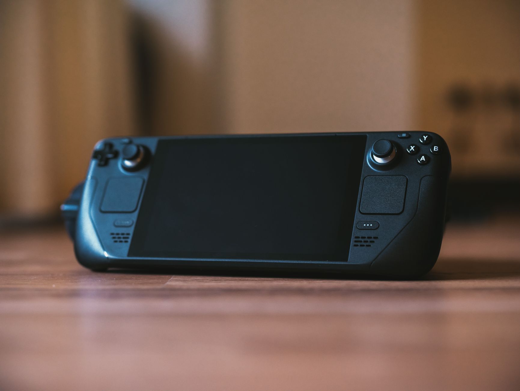 Handheld gaming screen displaying a game in low-light environment