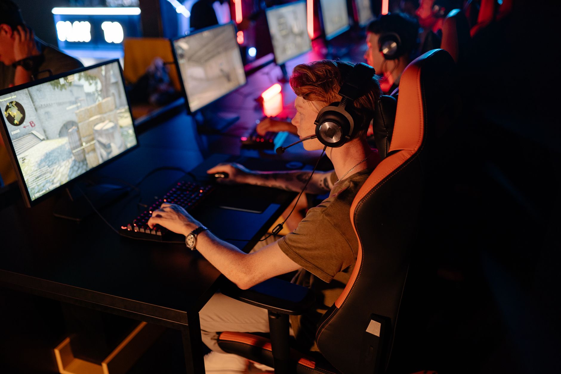 Competitive esports player focused on a monitor during a gaming session