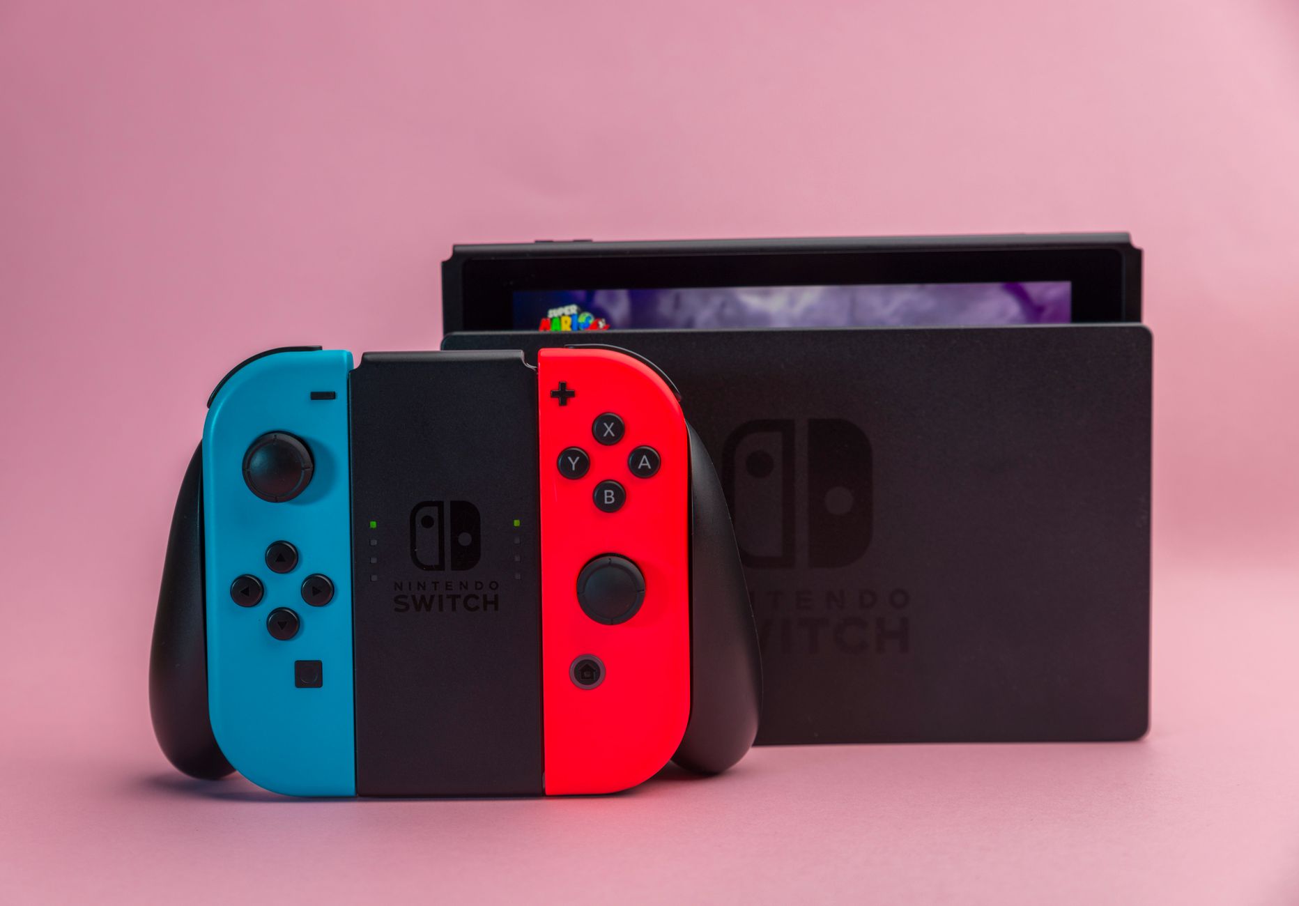 Two handheld gaming devices placed side by side on a flat surface for comparison
