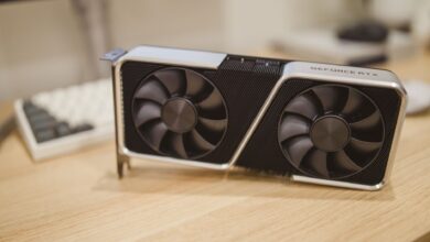 Close-up of a triple-fan GPU cooler with Windforce-style fan layout on a gaming graphics card