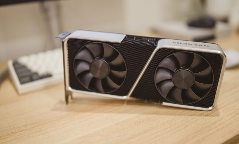 Close-up of a triple-fan GPU cooler with Windforce-style fan layout on a gaming graphics card