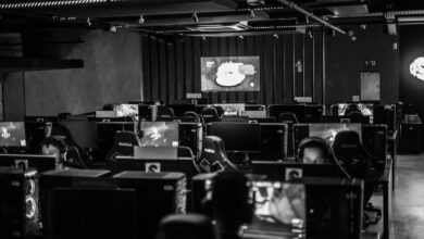 High-end gaming PC setup with dual monitors showing graphics benchmark results