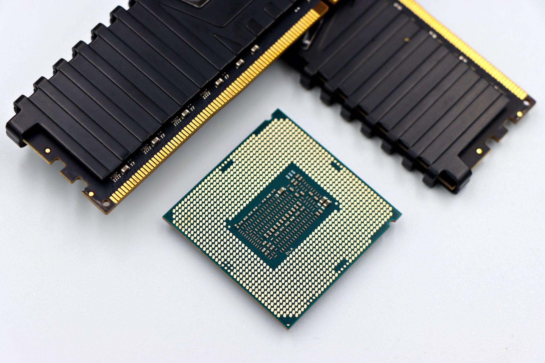 Two DDR5 RAM kits side by side on a dark surface showing heat spreaders and RGB lighting