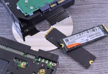 Two NVMe SSD drives side by side on a dark surface for comparison