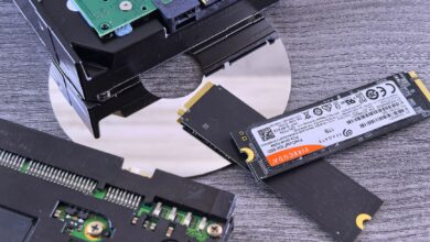 Two NVMe SSD drives side by side on a dark surface for comparison