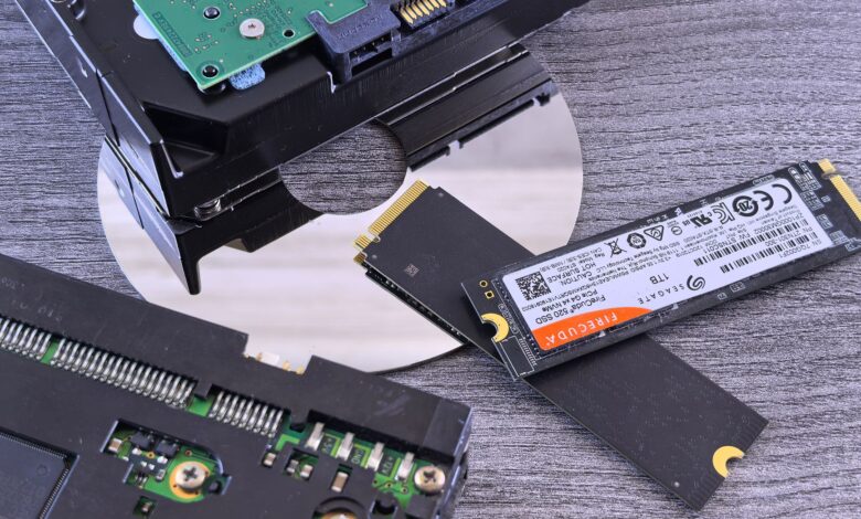 Two NVMe SSD drives side by side on a dark surface for comparison