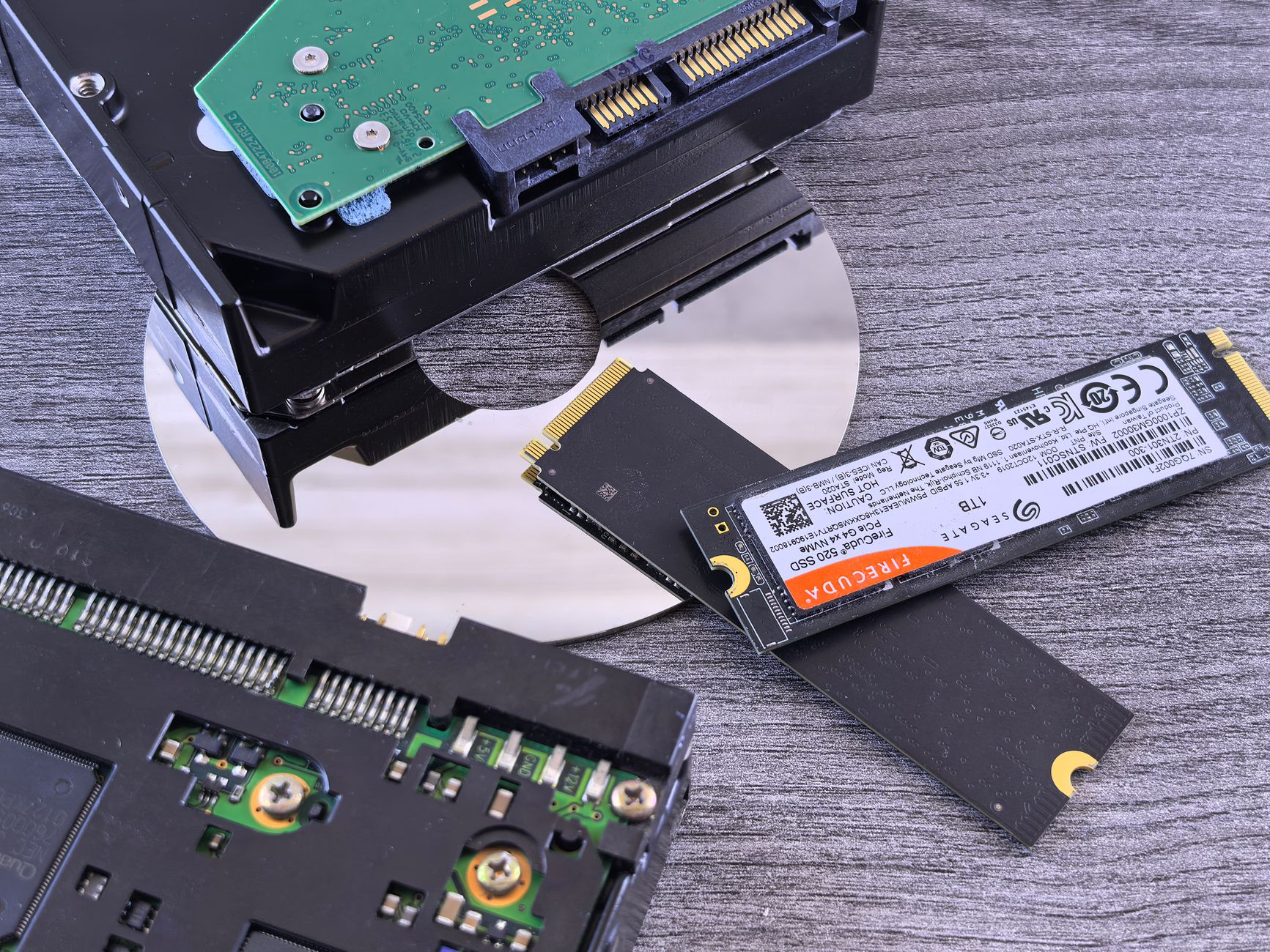 Two NVMe SSD drives side by side on a dark surface for comparison