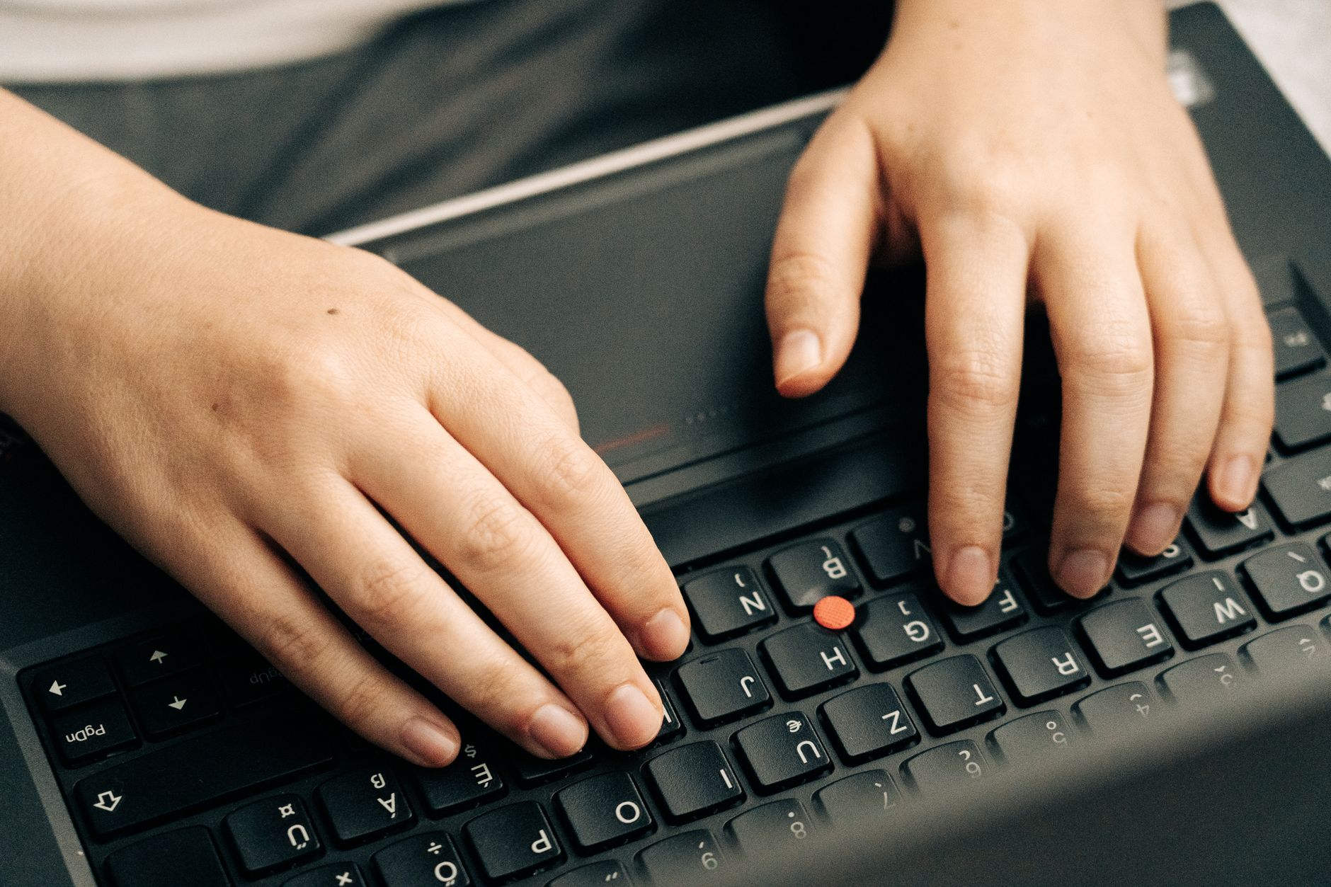 Hands typing on a mechanical keyboard during gaming session