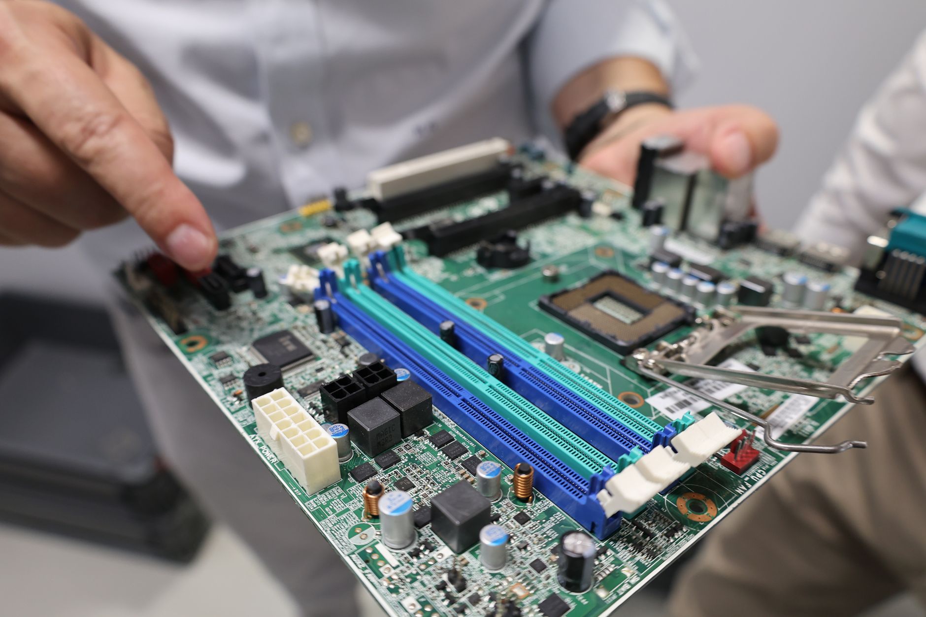 Graphics card components laid out for comparison on a clean desk surface