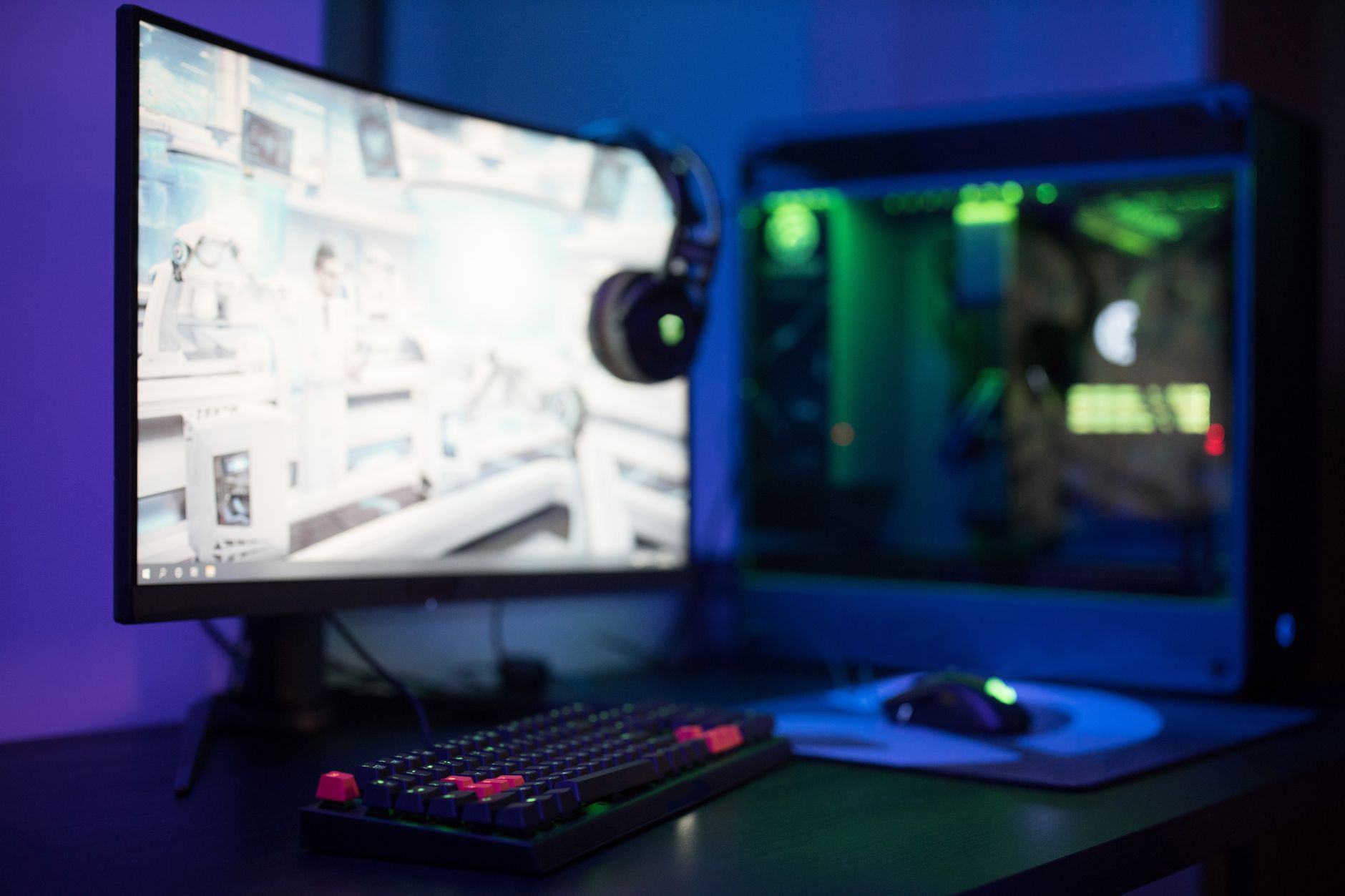 High-end gaming PC desktop setup with RGB lighting and dual monitors