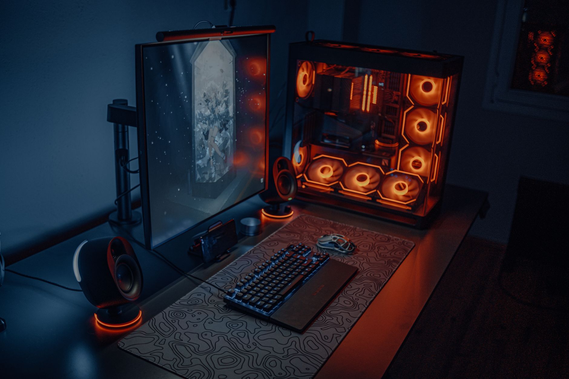 Gaming PC setup with glowing components on a desk