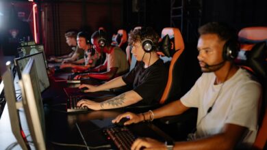 Packed esports arena with stage lighting during a live competitive event