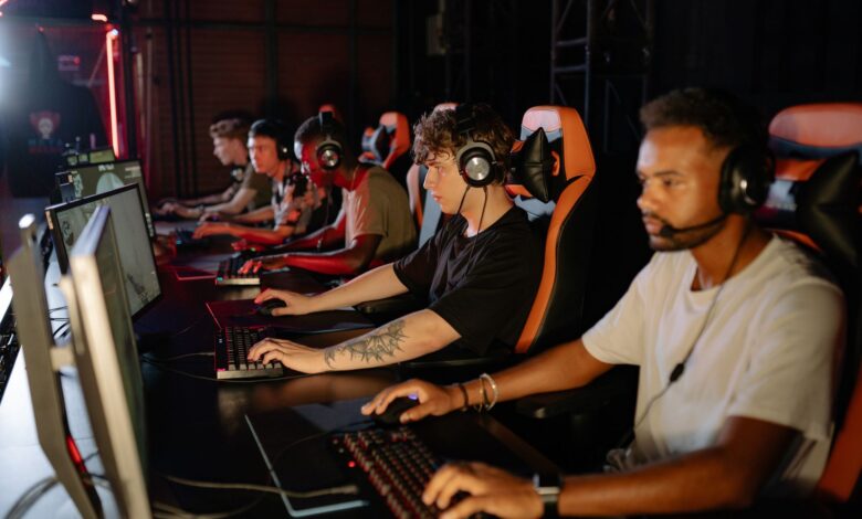 Packed esports arena with stage lighting during a live competitive event