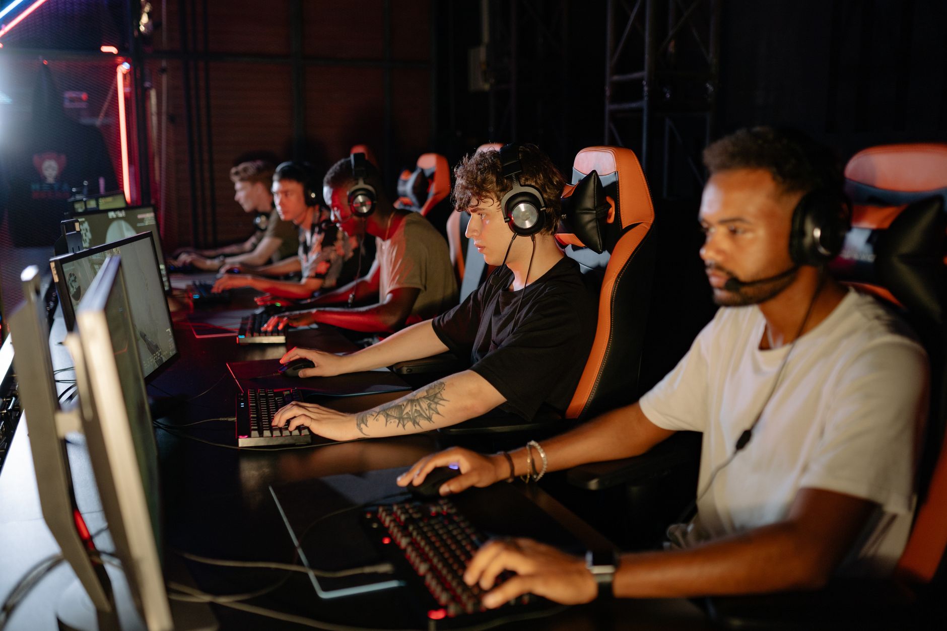 Packed esports arena with stage lighting during a live competitive event