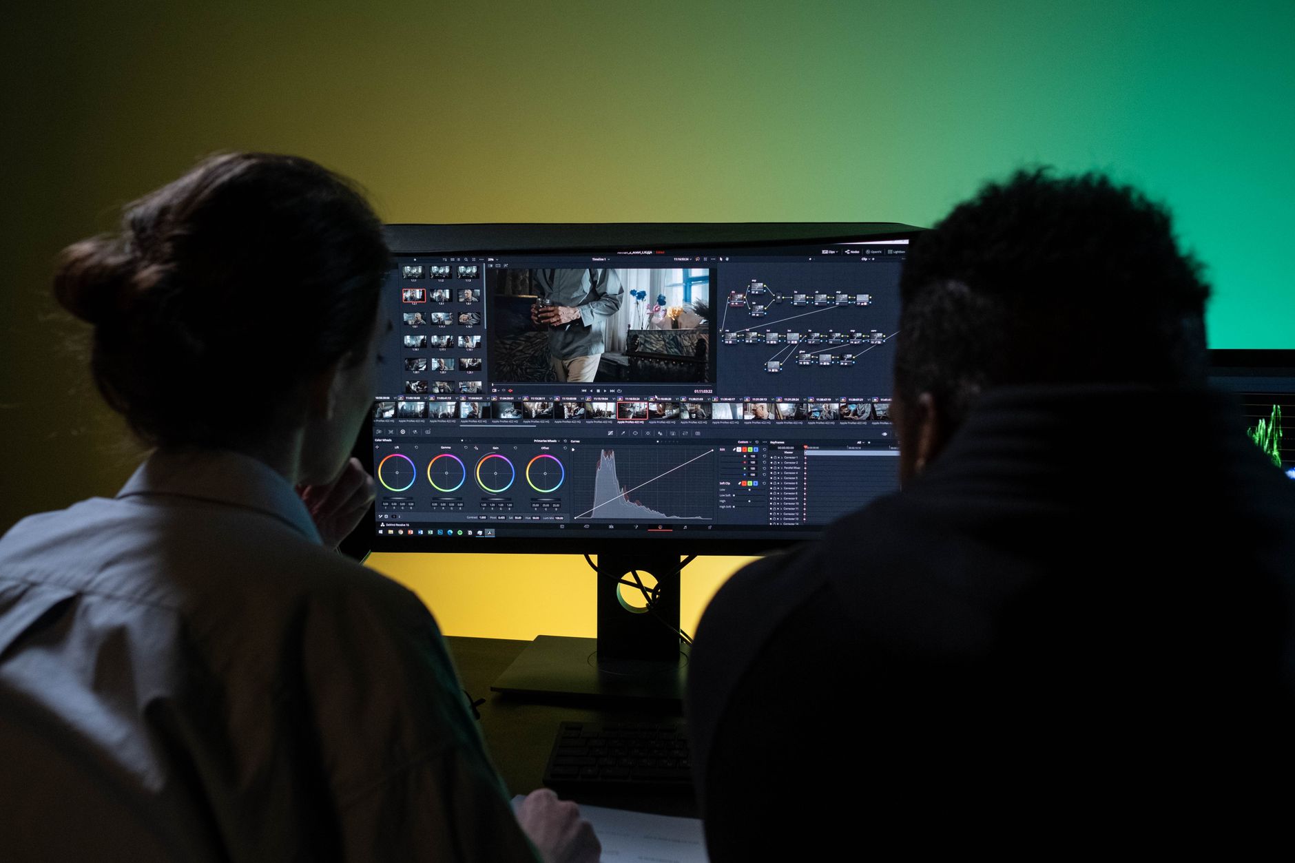 Content creator working on video editing software at a desktop workstation