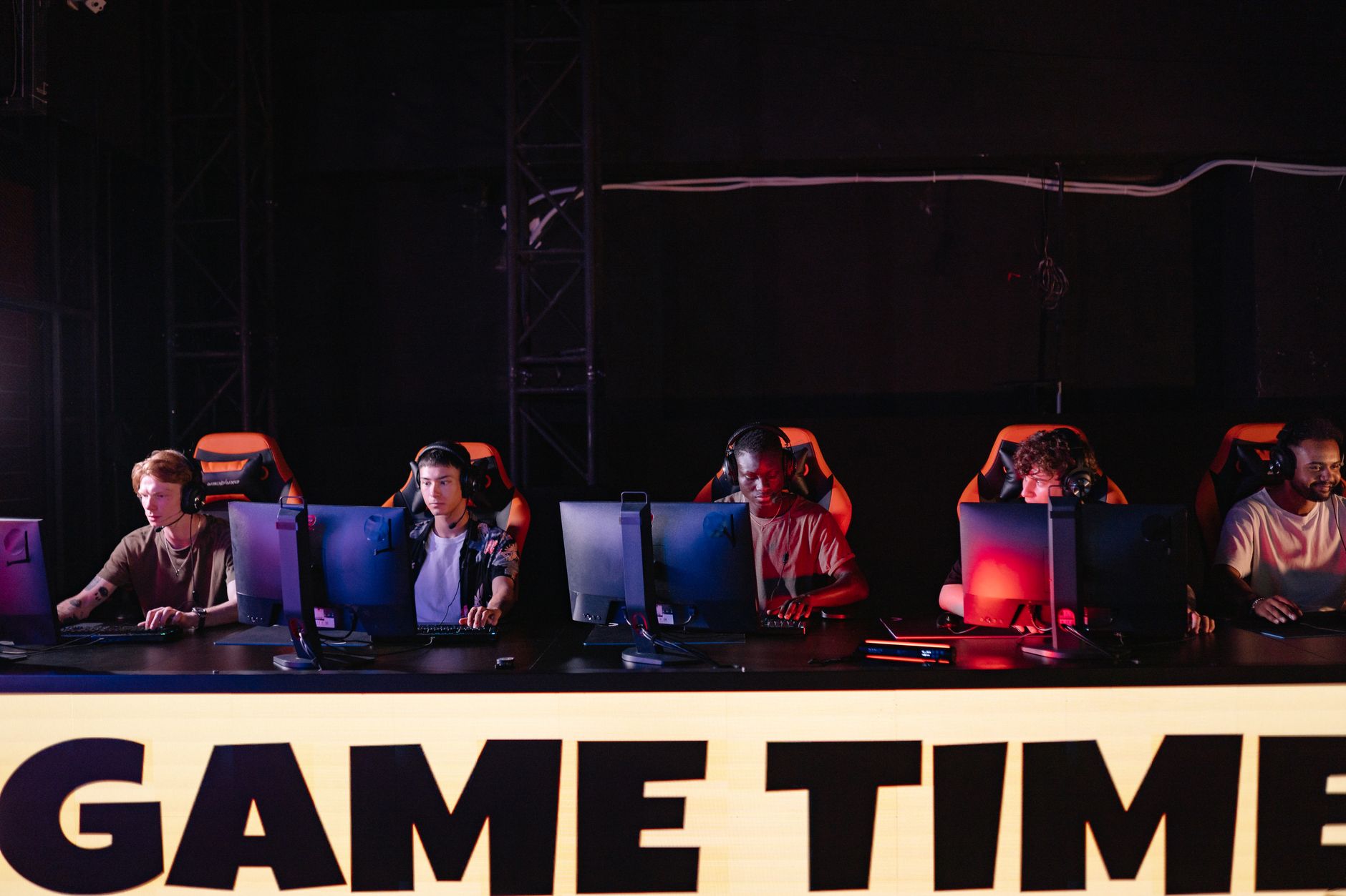 Professional esports team gathered around monitors during a competitive match